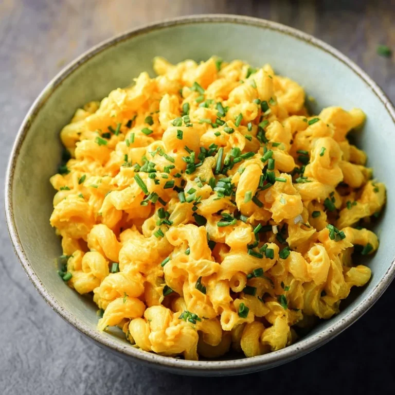 Delicious easy vegan curried pasta salad served in a bowl with colorful veggies.