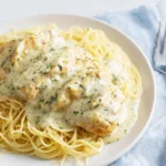 Crock Pot Angel Chicken dish served with creamy sauce and rice